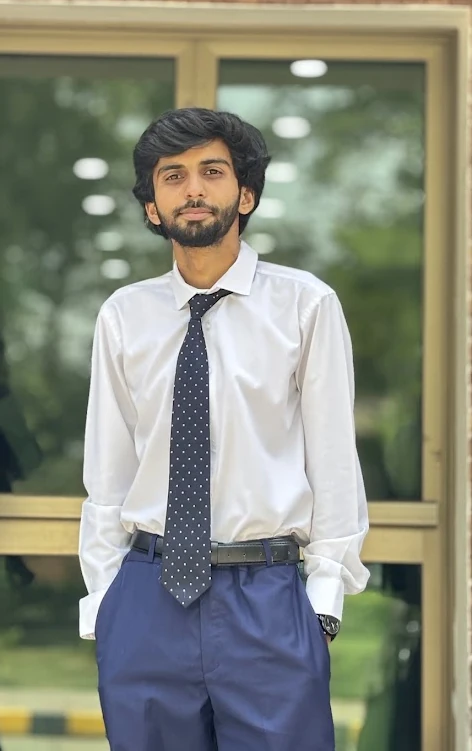 Muhammad Usman Ashraf in a white shirt and tie.